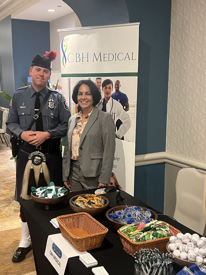 Anne White with a uniformed officer at the CBH Medical booth